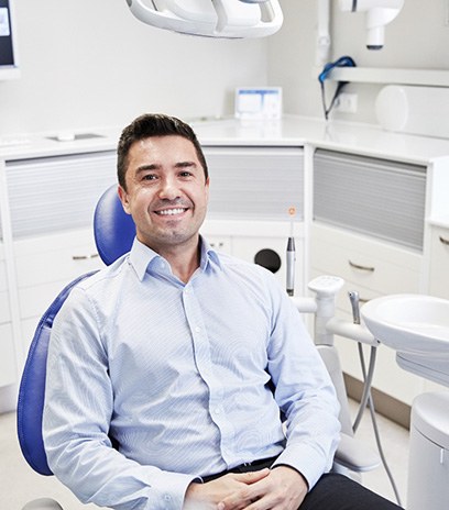 Male dental patient smiling after teeth whitening in Belmont, MA
