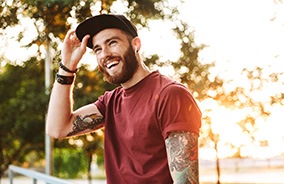 Man in baseball cap after teeth whitening in Belmont, MA