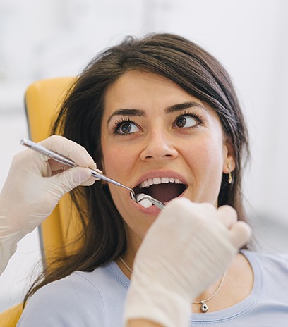 Young woman having wisdom tooth removed